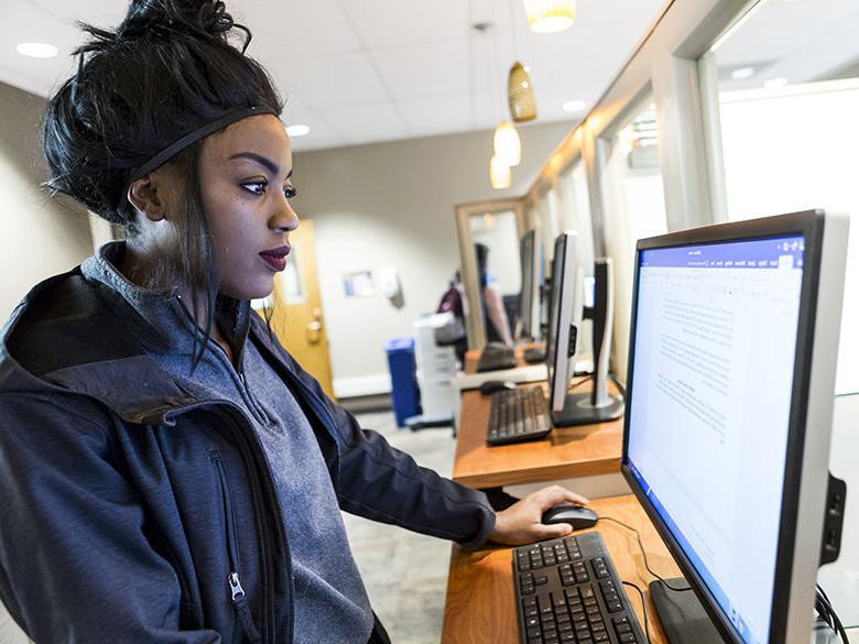 Female student works at computer station