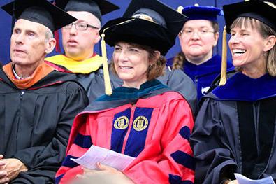 Faculty members sit together in regalia